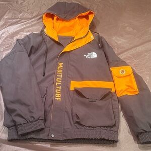 The North Face Kids Raincoat - Black and bold gold.